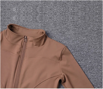Brown, long-sleeve, fitted polyester sport jacket with a zip closure for gym training and yoga.