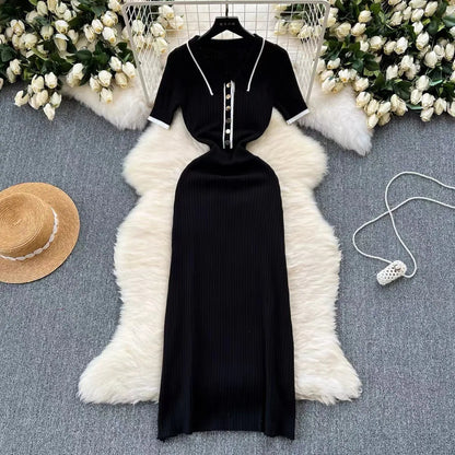 Black ribbed knit midi dress with white trim, polo neck, and buttons. A fitted piece for a polished daytime outfit.