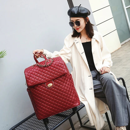 Red quilted PU rolling suitcase with a flap closure, gold-tone hardware, and a chain detail.