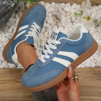 Blue suede and white leather sneakers with lace-up closure and gum soles, slip-on shoes for casual walking.