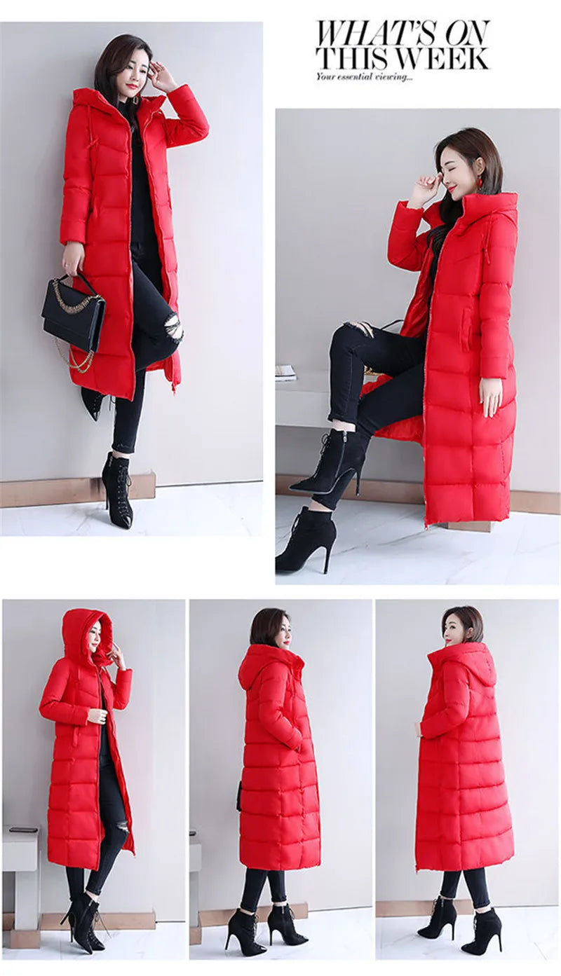 A woman wearing a bright red, long puffer parka with a hood and quilted design.