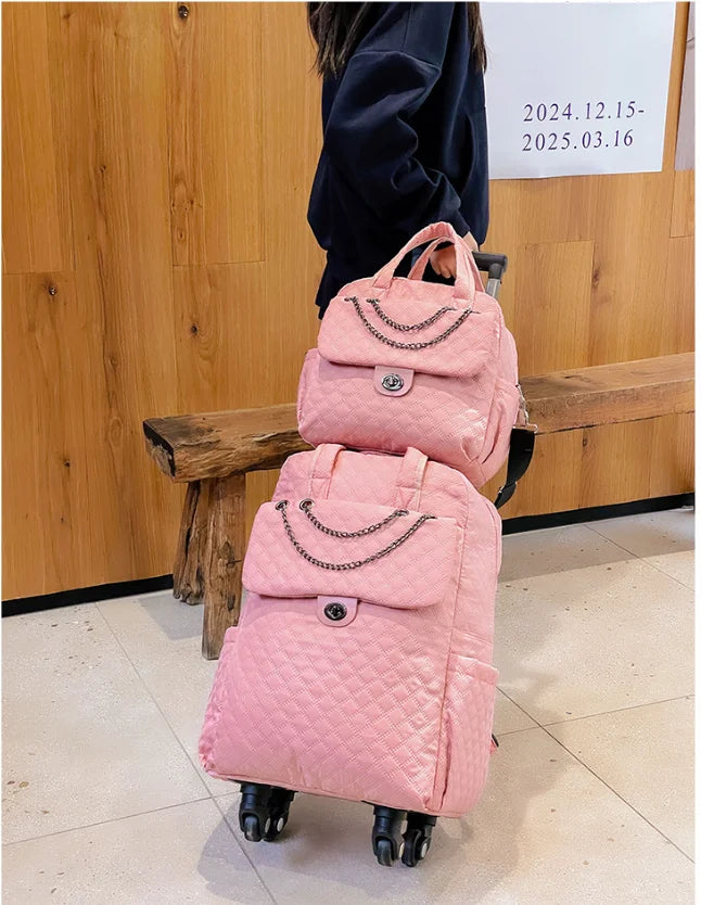 Pink quilted rolling backpack and matching handbag set with chain detail and turn-lock closures.