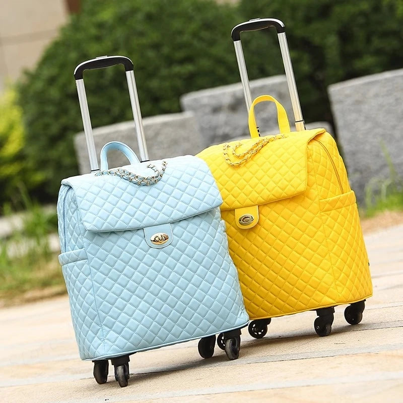 Light blue and yellow quilted PU leather rolling suitcases with gold chains, turn-lock closures, and extendable handles.