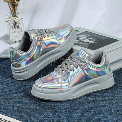 A pair of casual lace-up sneakers with holographic metallic uppers and thick grey platform soles.