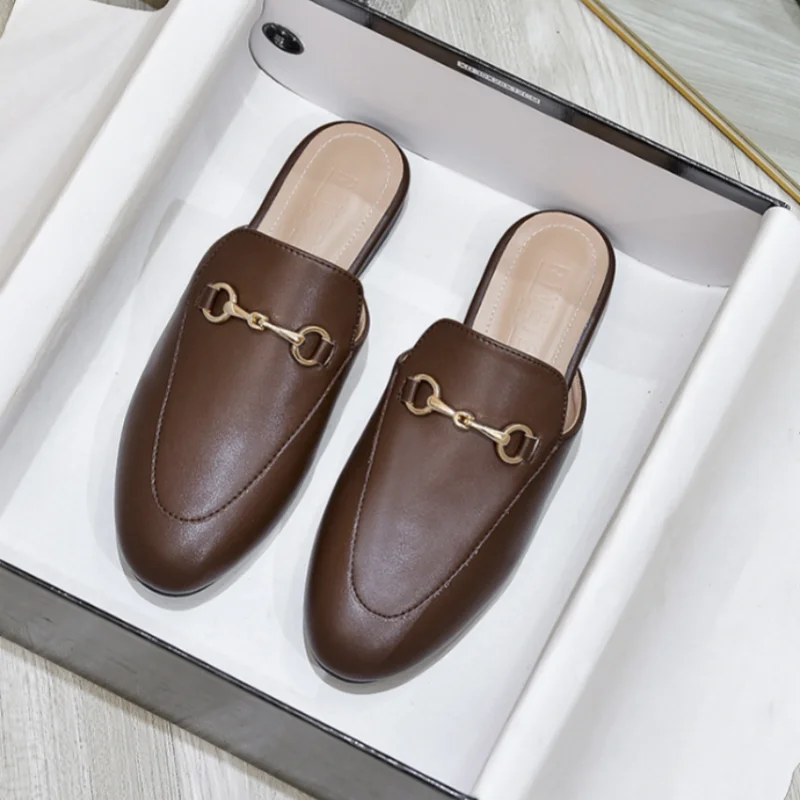 Brown slip-on mules with gold chain detail in a white box for casual daily wear.