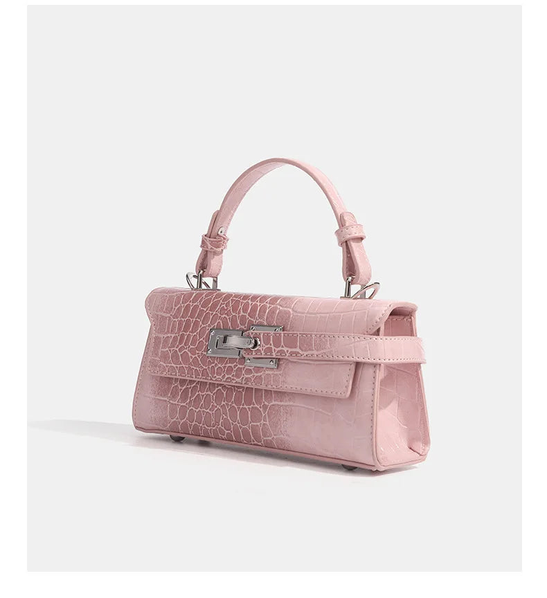 Pink faux leather structured crossbody bag with a croc texture and silver metal clasp for daily errands.