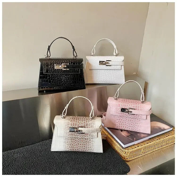 Black, white, pink, and ombre faux leather crossbody diaper bags with structured designs and multi-pocket storage for moms.