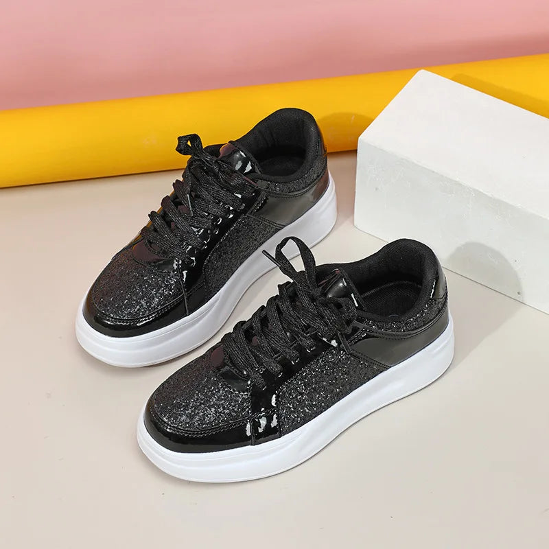 Black sequin and patent leather lace-up casual sneakers with thick white soles.