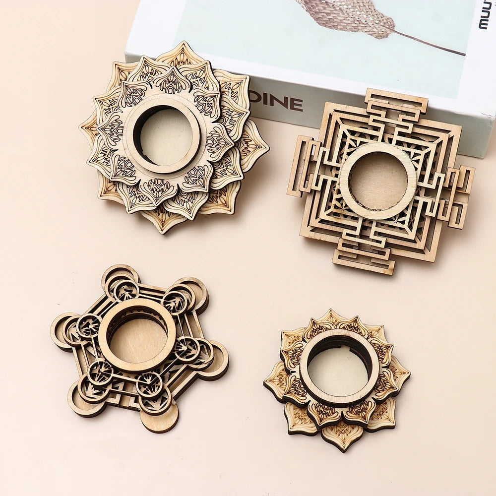 Four light brown wooden crystal ball stands with lotus, geometric, and mandala-inspired laser-cut patterns.
