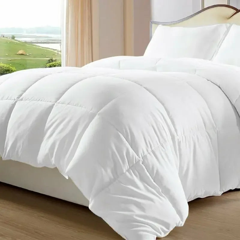 White goose down comforter on a bed with square baffle-box stitching, creating a plush, quilted duvet look.