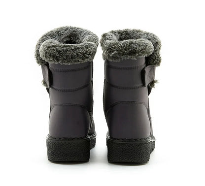 Grey waterproof ankle snow boots with faux fur trim and flat soles viewed from the back.