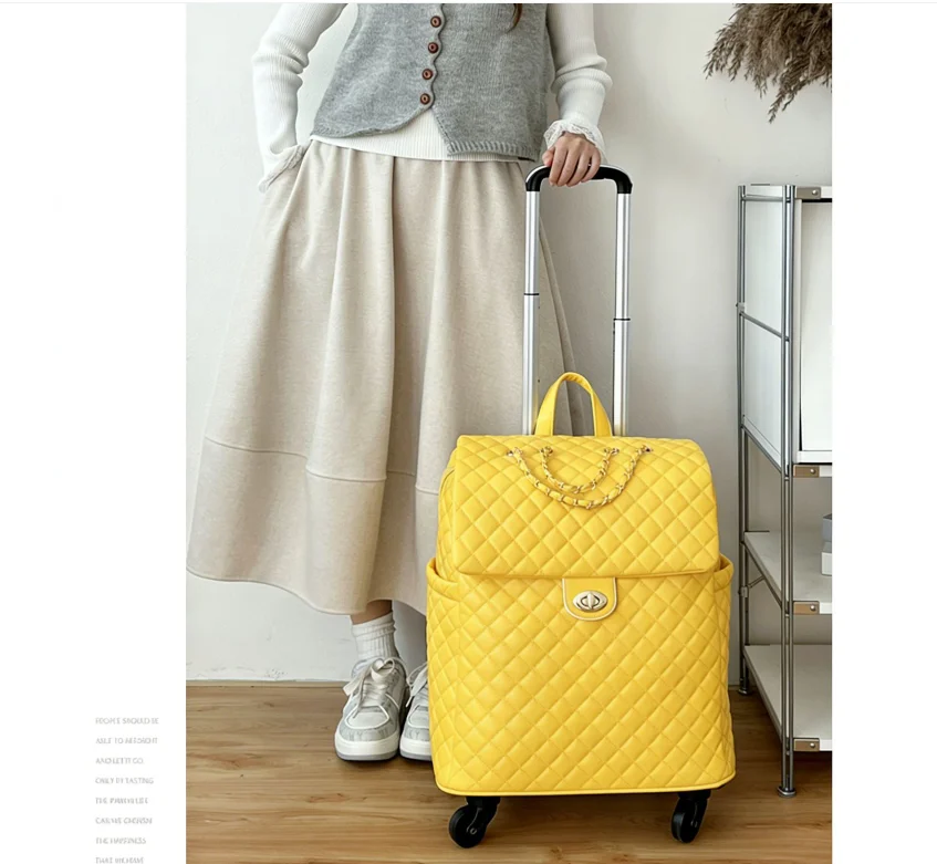 Yellow quilted faux leather rolling travel bag with a gold chain and turn-lock closure on the front flap.