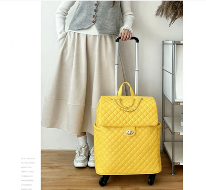Yellow quilted faux leather rolling travel bag with a gold chain and turn-lock closure on the front flap.