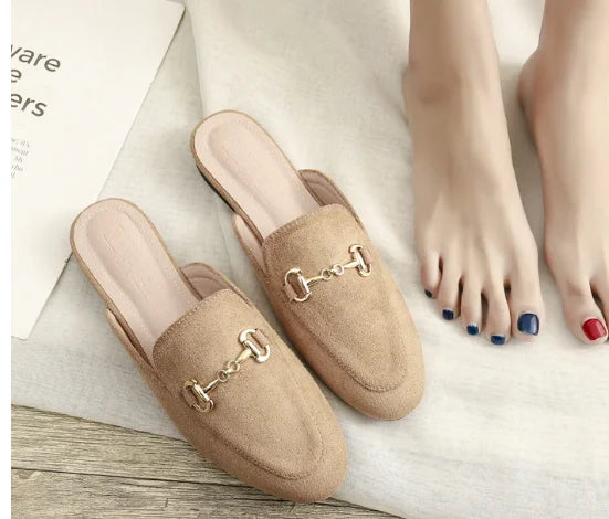 Tan suede slip-on mules with a gold metal chain detail for everyday outdoor wear.