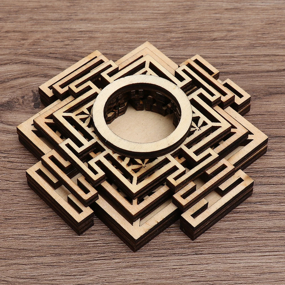 Brown wooden crystal ball holder with geometric laser-cut layered square and circular designs.