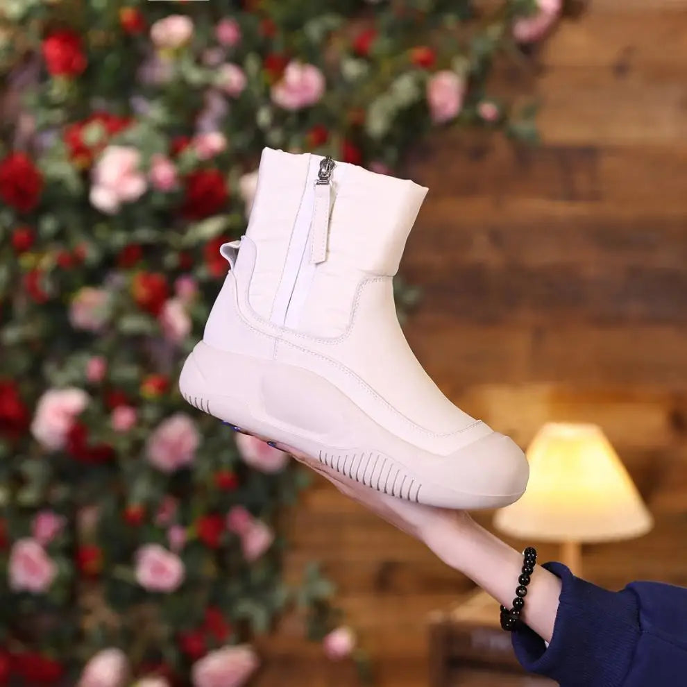 White winter boot with side zipper, thick sole, and a quilted upper design.