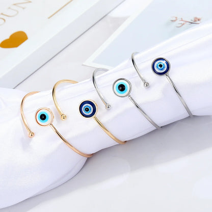 Adjustable cuff bracelet with a geometric evil eye motif