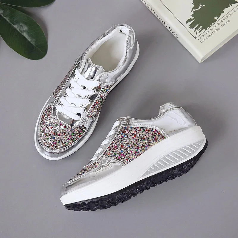 Silver lace-up platform sneakers with colorful glitter panels, white laces, and thick wedge soles.