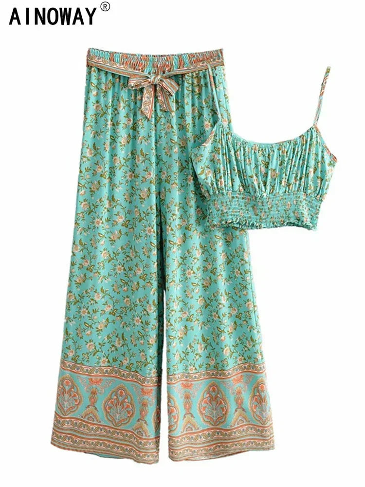 Teal floral flowy two-piece set featuring wide leg pants and a smocked crop top for a comfortable summer outfit.