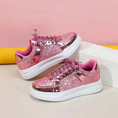 Pink glitter and metallic casual lace-up sneakers with thick white soles.