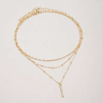 Women's gold-tone layered chain necklace with pendant detail