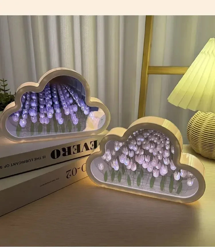 Cloud-shaped LED home decor with mirror panels and purple tulip flowers, providing ambient light for a desk.