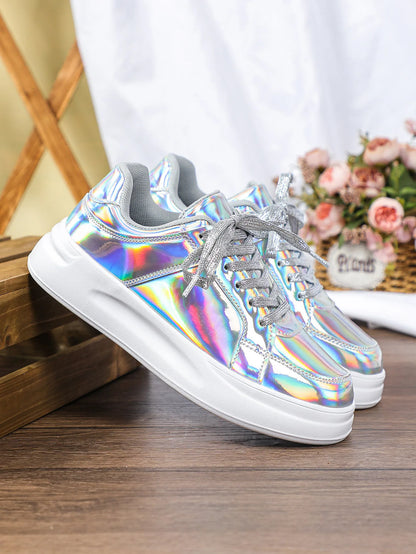 Shiny silver holographic lace-up casual sneakers with thick white soles and sparkly silver laces.
