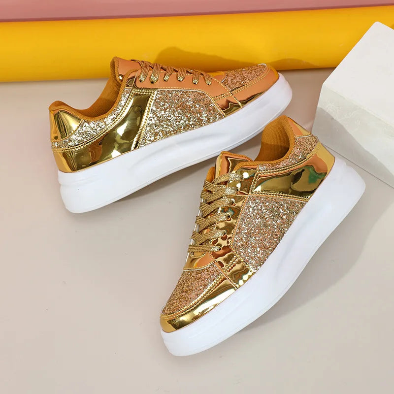 Gold sequin and metallic lace-up sneakers with thick white soles.