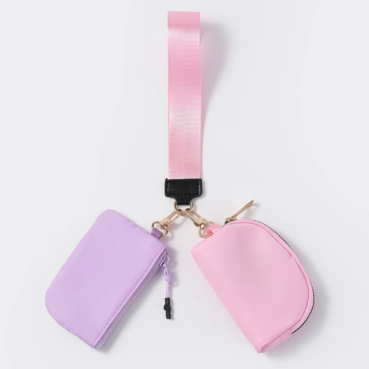 Pink and lavender nylon zip closure wristlet wallet with dual pouches for hands-free carrying of cards and keys.