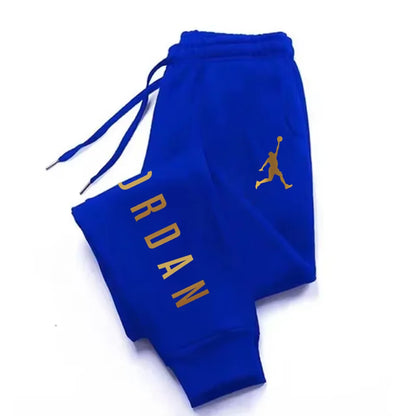 Blue stretchy joggers with gold letter print and drawstring waist for athletic wear.