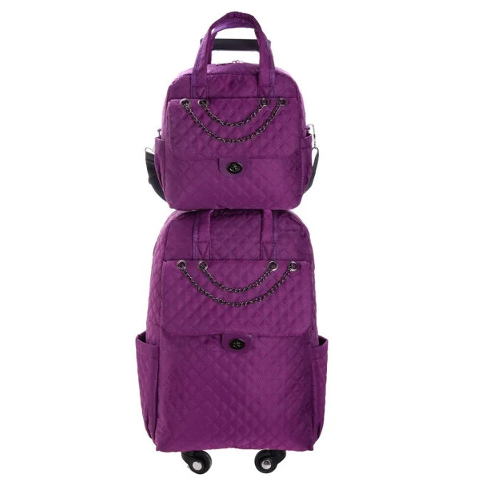 Purple quilted nylon rolling luggage set with chain accents and dual wheels.