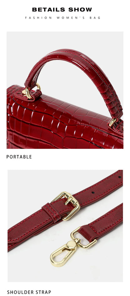 Red crocodile-pattern leather handbag with top handle and adjustable shoulder strap with gold hardware.