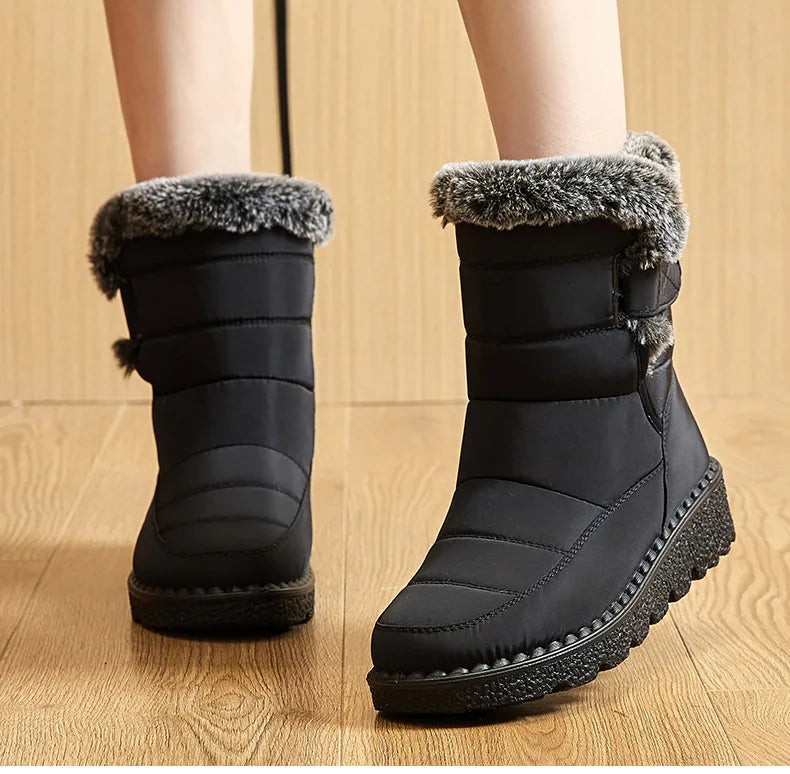 Black quilted synthetic winter boots with grey faux fur collars and thick treaded soles.