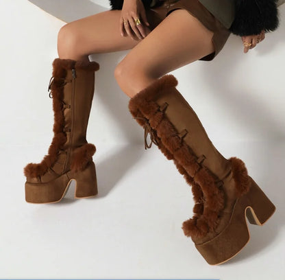 Brown suede platform wedge mid-calf boots with faux fur trim, side zippers, and lace details.