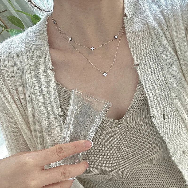 Women's gold-tone layered chain necklace with pendant detail