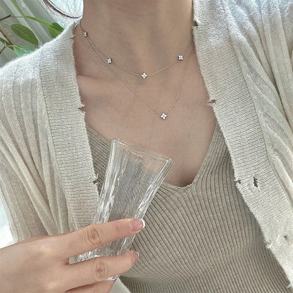 Women's gold-tone layered chain necklace with pendant detail