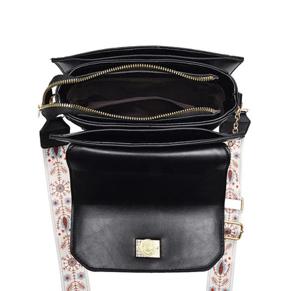 Black faux leather shoulder bag, top-down view showing zippered compartments and a patterned strap.