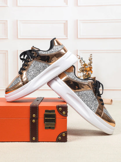 Rose gold metallic and silver glitter sneakers with thick white soles and black laces.