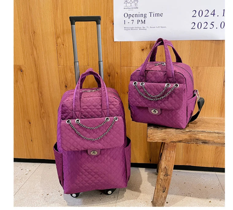 Two purple quilted nylon travel bags with chain accents and twist locks; one is a rolling backpack with a handle.