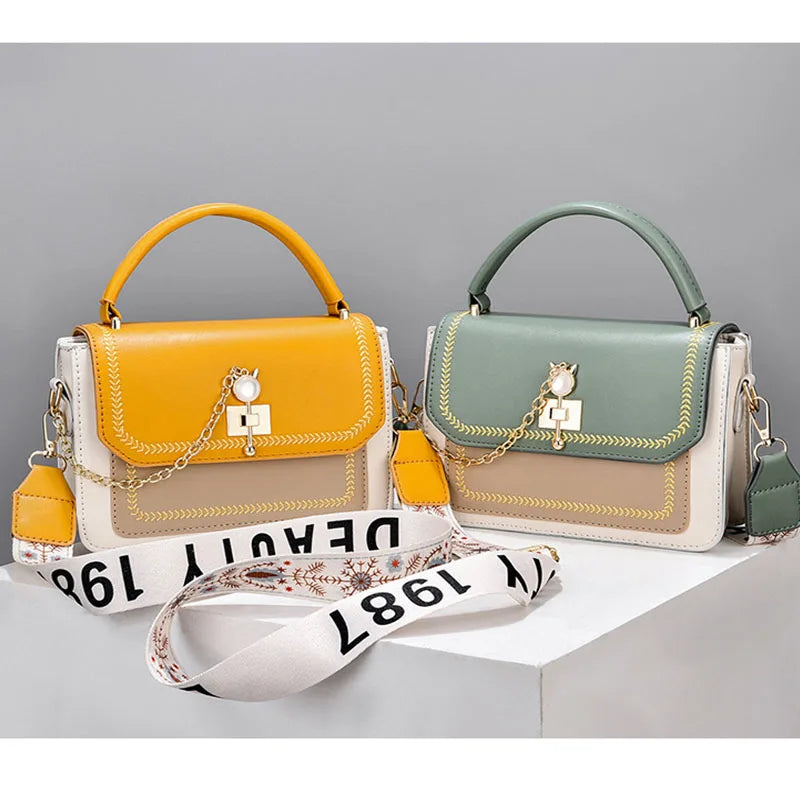 Two structured leather handbags with top handles, turn-lock closures, pearl accents, and broad straps.