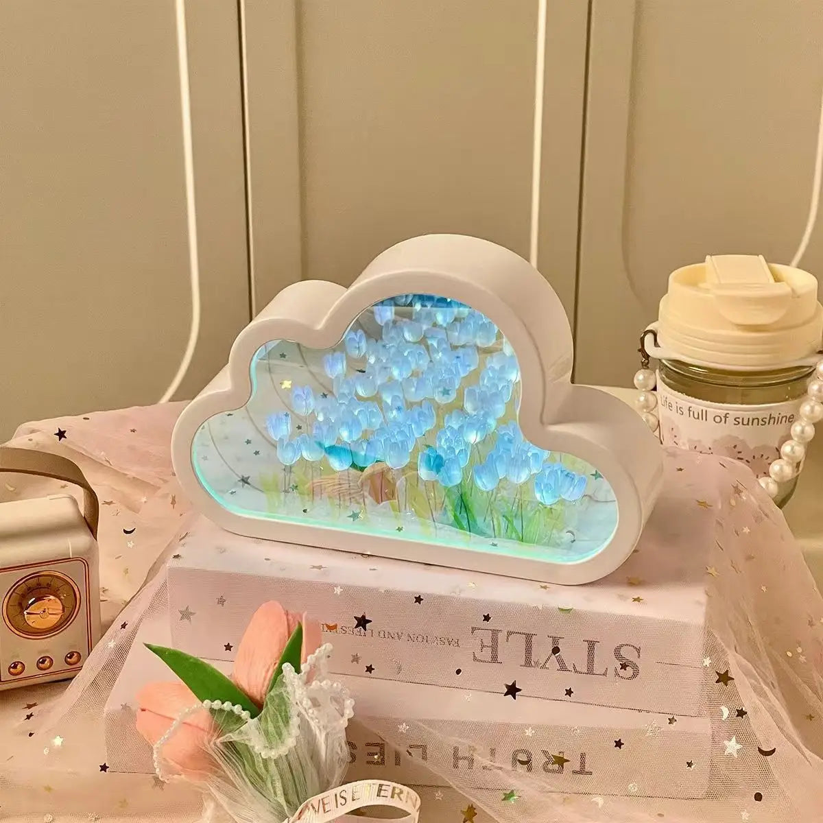 Cloud-shaped mirror panel with blue tulip LED home decor for ambient desk lighting.