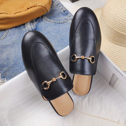 Black slip-on shoes with gold chain detail and textured alligator pattern for all day wear.