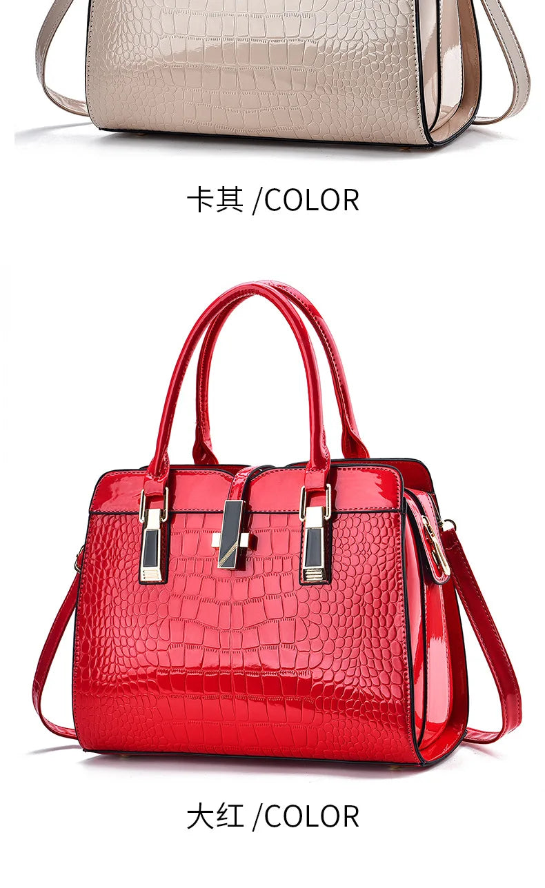 Red crocodile-pattern leather handbag with dual top handles, structured tote style, and gold-tone hardware accents.