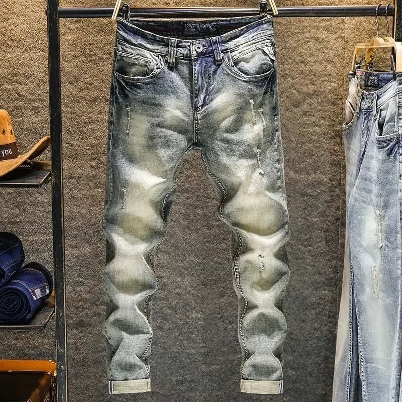 Blue distressed tapered jeans made of stretchy denim for daily wear.