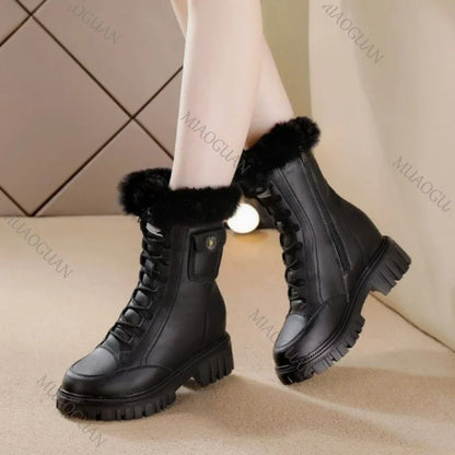 Black leather chunky snow boots with faux fur trim, lace-up front, platform sole, and side pocket detail.