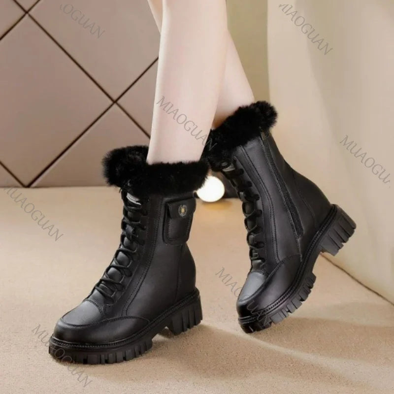 Black leather platform snow boots with chunky heels, lace-ups, fur trim, and a small side pocket.