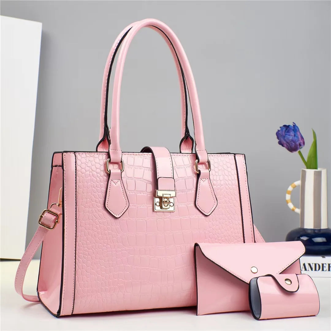 Pink crocodile-pattern faux leather handbag set with top handles and two matching wallets.