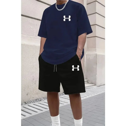 Navy blue short sleeve tee and black drawstring shorts in relaxed knit for athletic wear.