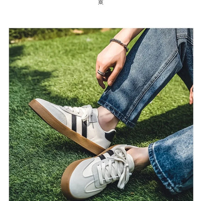 White and black canvas sneakers with brown gum soles, breathable training shoes for casual wear.