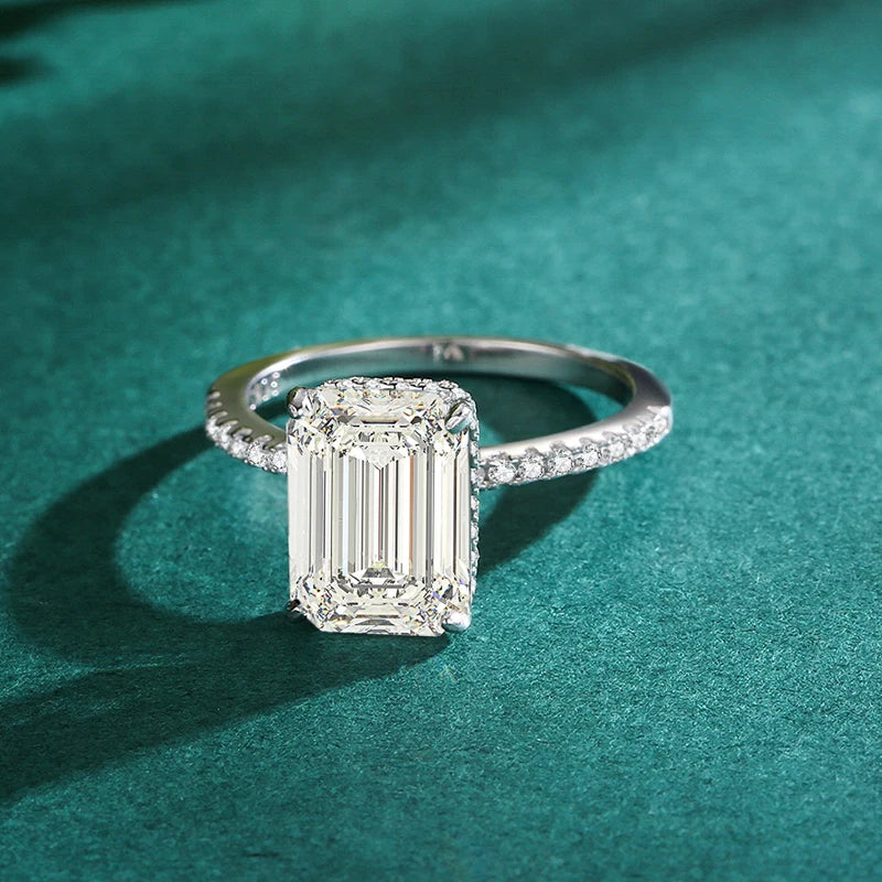 Silver sterling ring with a large emerald-cut rectangular center stone and pavé-set zirconia band.